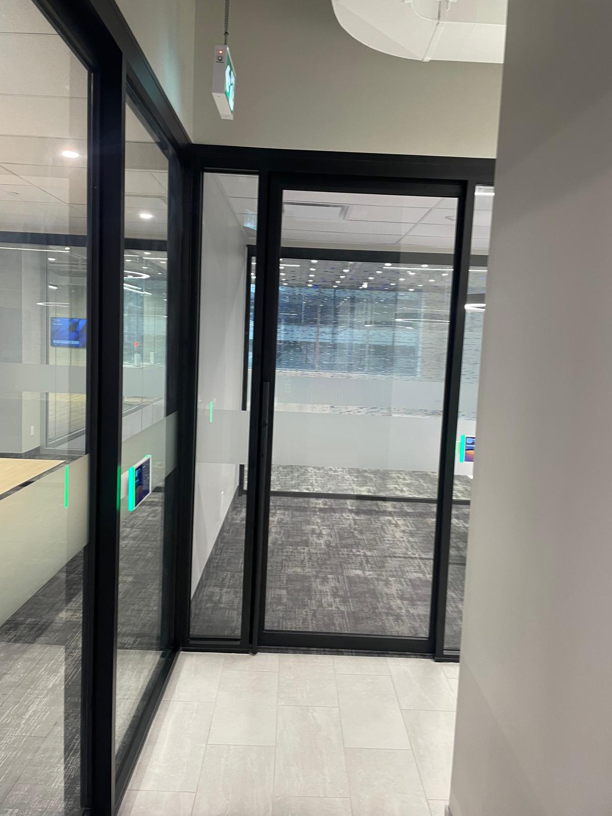 345 King Suite 200 black-framed office entrance and bright corridor