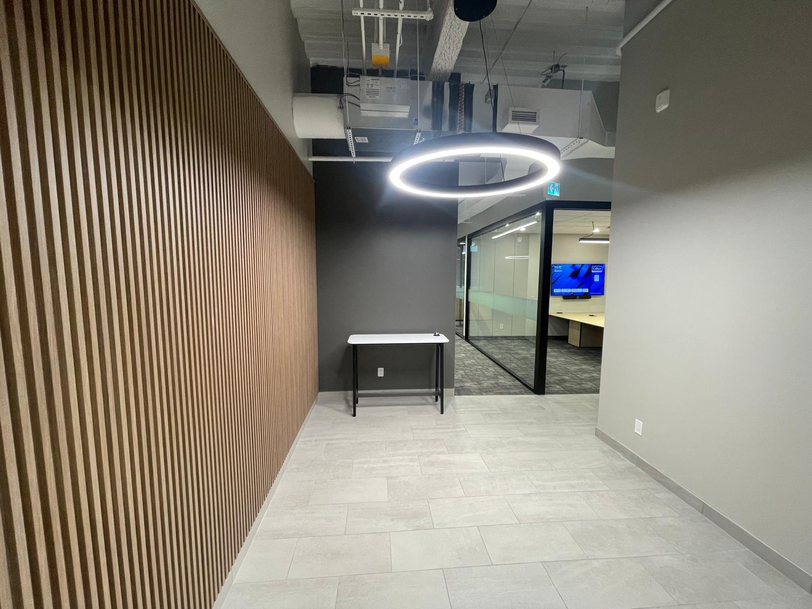 345 King Suite 200 wood-slat wall, ring light, and glass meeting room